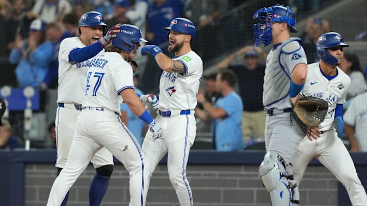 Oct 24, 2025; Toronto, Ontario, CAN; Toronto Blue Jays third baseman Addison Barger (47) celebrates with right fielder George Springer (4) and right fielder Nathan Lukes (38) after hitting a grand slam home run against the Los Angeles Dodgers in the sixth inning during game one of the 2025 MLB World Series at Rogers Centre. Mandatory Credit: Nick Turchiaro-Imagn Images Oct 24, 2025; Toronto, Ontario, CAN; Toronto Blue Jays third baseman Addison Barger (47) celebrates with right fielder George Springer (4) and right fielder Nathan Lukes (38) after hitting a grand slam home run against the Los Angeles Dodgers in the sixth inning during game one of the 2025 MLB World Series at Rogers Centre. Mandatory Credit: Nick Turchiaro-Imagn Images