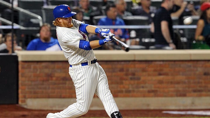 Aug 28, 2013; New York, NY, USA; New York Mets shortstop Justin Turner (2) hits a double against the Philadelphia Phillies during the second inning of a game at Citi Field. 