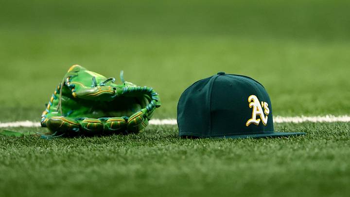 Jul 22, 2025; Arlington, Texas, USA; Athletics glove and hat on the field before the game against the Texas Rangers at Globe Life Field. Mandatory Credit: Kevin Jairaj-Imagn Images