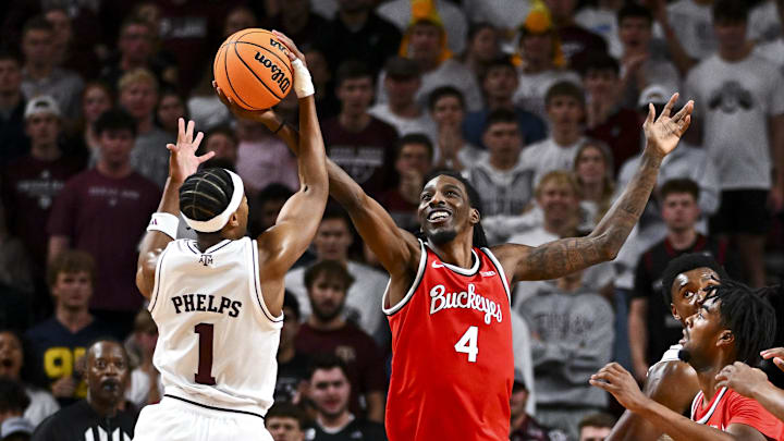 Nov 15, 2024; College Station, Texas, USA; Ohio State Buckeyes forward Aaron Bradshaw (4) and Texas A&M Aggies guard Zhuric Phelps (1) battle for a passes ball during the first half at Reed Arena. Mandatory Credit: Maria Lysaker-Imagn Images 