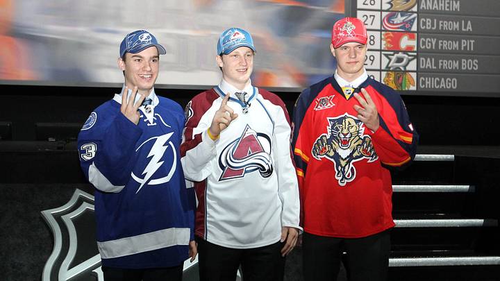 Jun 30, 2013; Newark, NJ, USA; Number one overall draft pick Nathan MacKinnon (middle) , number two overall pick Aleksander Barkov (right) and number three overall pick Jonathan Drouin (left) pose for photos during the 2013 NHL Draft at the Prudential Center. Mandatory Credit: Ed Mulholland-Imagn Images