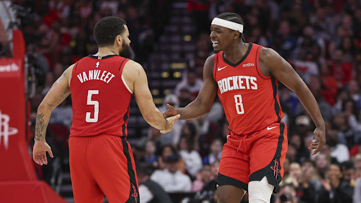 Jan 1, 2025; Houston, Texas, USA; Houston Rockets forward Jae'Sean Tate (8) celebrates with guard Fred VanVleet (5) after scoring a basket during the third quarter against the Dallas Mavericks at Toyota Center. Mandatory Credit: Troy Taormina-Imagn Images