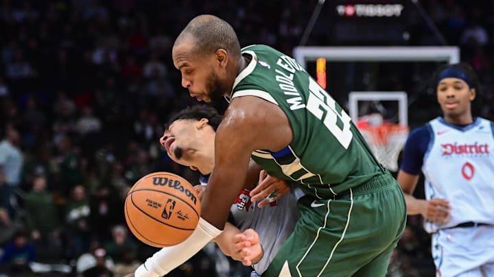 Dec 21, 2024; Milwaukee, Wisconsin, USA; Milwaukee Bucks forward Khris Middleton (22) collides with Washington Wizards guard Jordan Poole (13) in the third quarter at Fiserv Forum. Mandatory Credit: Benny Sieu-Imagn Images