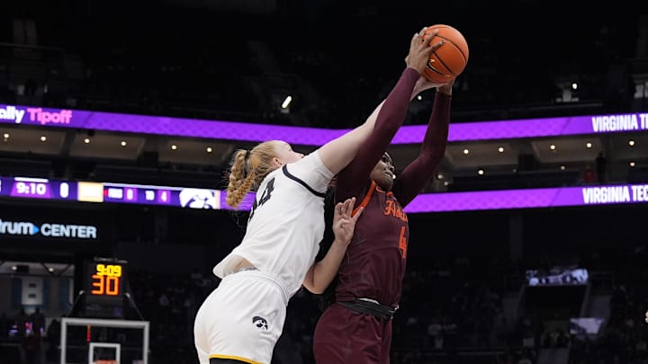 Nov 10, 2024; Charlotte, NC, USA; Iowa Hawkeyes forward Addison O'Grady (44) after the ball from Virginia Tech Hokies forward Rose Micheaux (4) during the first half at Spectrum Center. Mandatory Credit: Jim Dedmon-Imagn Images Nov 10, 2024; Charlotte, NC, USA; Iowa Hawkeyes forward Addison O'Grady (44) after the ball from Virginia Tech Hokies forward Rose Micheaux (4) during the first half at Spectrum Center. Mandatory Credit: Jim Dedmon-Imagn Images