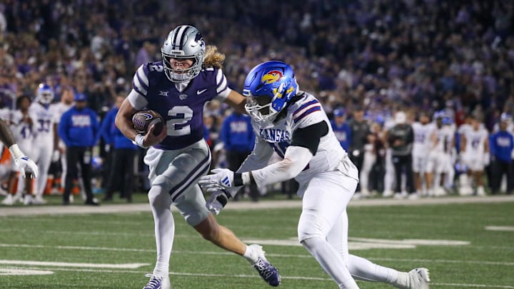 Oct 26, 2024; Manhattan, Kansas, USA; Kansas State Wildcats quarterback Avery Johnson (2) runs by Kansas Jayhawks defensive end Jereme Robinson (90) on his way to a touchdown in the fourth quarter at Bill Snyder Family Football Stadium. Mandatory Credit: Scott Sewell-Imagn Images