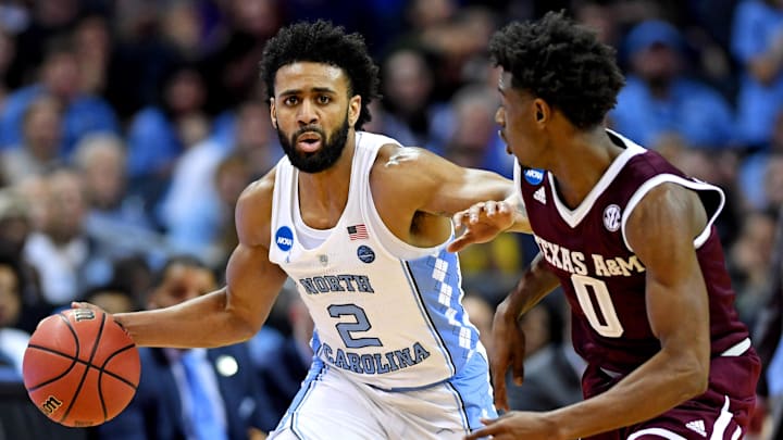 Mar 18, 2018; Charlotte, NC, USA; North Carolina Tar Heels guard Joel Berry II (2) brings the ball up court against Texas A&M Aggies guard Jay Jay Chandler (0) during the first half in the second round of the 2018 NCAA Tournament at Spectrum Center. Mandatory Credit: Bob Donnan-Imagn Images
