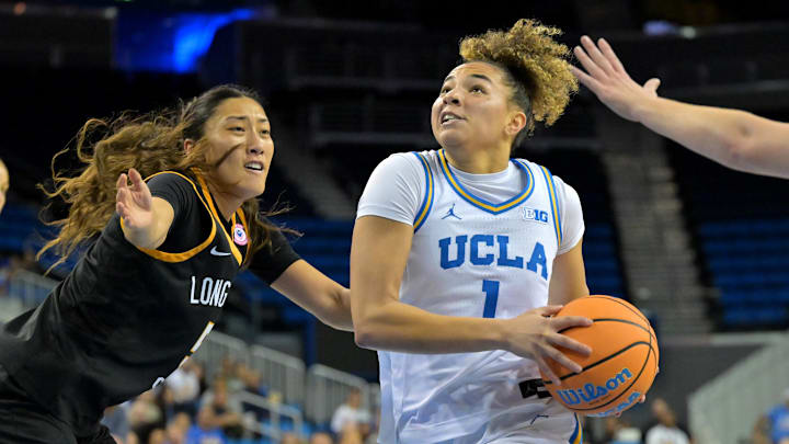 Dec 20, 2025; Los Angeles, California, USA; UCLA Bruins guard Kiki Rice (1) drives past Long Beach State Beach forward Kennan Ka (5) for a basket during the first half at Pauley Pavilion presented by Wescom Financial. Mandatory Credit: Jayne Kamin-Oncea-Imagn Images