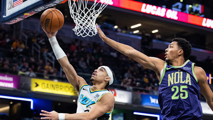 Dec 15, 2024; Indianapolis, Indiana, USA; Indiana Pacers guard Andrew Nembhard (2) shoots the ball while New Orleans Pelicans guard Trey Murphy III (25) defends in the second half at Gainbridge Fieldhouse. Mandatory Credit: Trevor Ruszkowski-Imagn Images