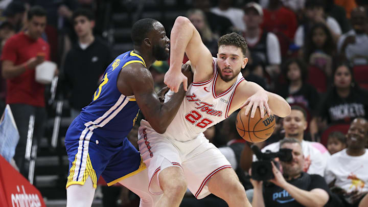 Mar 5, 2026; Houston, Texas, USA; Golden State Warriors forward Draymond Green (23) defends against Houston Rockets center Alperen Sengun (28) during the second quarter at Toyota Center. Mandatory Credit: Troy Taormina-Imagn Images