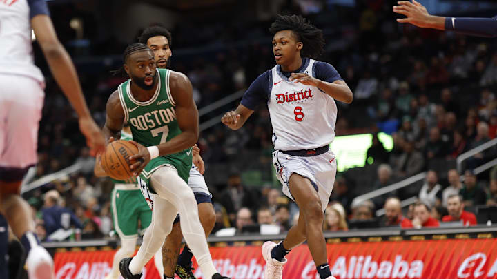 Dec 15, 2024; Washington, District of Columbia, USA; Boston Celtics guard Jaylen Brown (7) drives to the basket s Washington Wizards guard Bub Carrington (8) defends in the first quarter at Capital One Arena. Mandatory Credit: Geoff Burke-Imagn Images