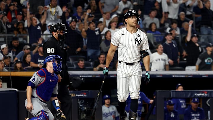 Oct 30, 2024; New York, New York, USA; New York Yankees designated hitter Giancarlo Stanton (27) reacts after hitting a home run during the third inning against the Los Angeles Dodgers in game five of the 2024 MLB World Series at Yankee Stadium.