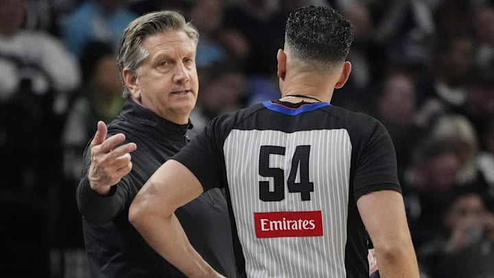 Apr 11, 2025; Minneapolis, Minnesota, USA; Minnesota Timberwolves head coach Chris Finch talks with referee Ray Acosta in the fourth quarter of the game with the Brooklyn Nets at Target Center. Mandatory Credit: Bruce Kluckhohn-Imagn Images