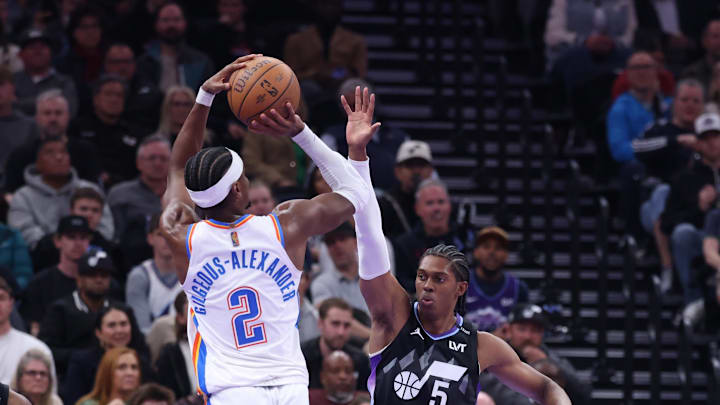 Nov 21, 2025; Salt Lake City, Utah, USA; Oklahoma City Thunder guard Shai Gilgeous-Alexander (2) shoots as Utah Jazz forward Cody Williams (5) defends during the second half at Delta Center. Mandatory Credit: Rob Gray-Imagn Images