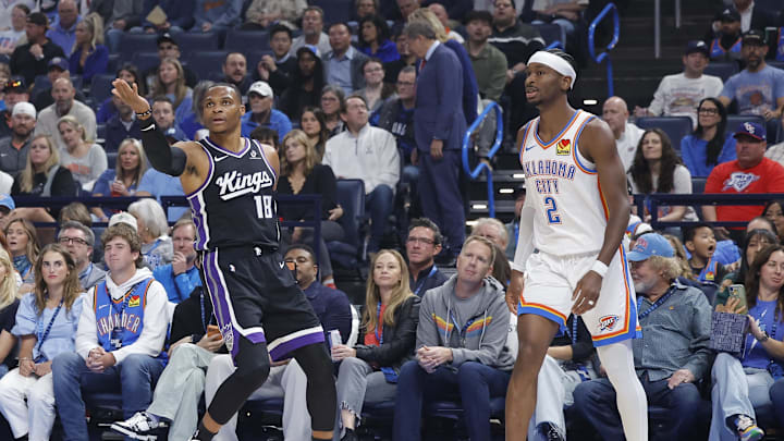 Oct 28, 2025; Oklahoma City, Oklahoma, USA; Sacramento Kings guard Russell Westbrook (18) gestures after scoring a three point basket against Oklahoma City Thunder guard Shai Gilgeous-Alexander (2) during the first quarter at Paycom Center. Mandatory Credit: Alonzo Adams-Imagn Images Oct 28, 2025; Oklahoma City, Oklahoma, USA; Sacramento Kings guard Russell Westbrook (18) gestures after scoring a three point basket against Oklahoma City Thunder guard Shai Gilgeous-Alexander (2) during the first quarter at Paycom Center. Mandatory Credit: Alonzo Adams-Imagn Images