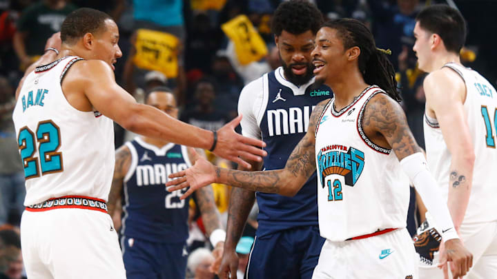 Apr 18, 2025; Memphis, Tennessee, USA; Memphis Grizzlies guard Ja Morant (12) reacts with guard Desmond Bane (22) during the first quarter against the Dallas Mavericks at FedExForum. Mandatory Credit: Petre Thomas-Imagn Images