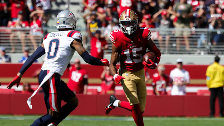 Sep 29, 2024; Santa Clara, California, USA; San Francisco 49ers wide receiver Jauan Jennings (15) runs the ball against New England Patriots cornerback Christian Gonzalez (0) during the second quarter at Levi's Stadium.