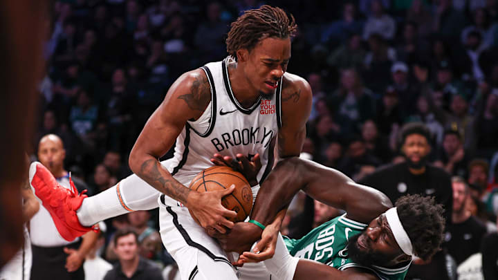 Nov 13, 2024; Brooklyn, New York, USA; Brooklyn Nets center Nic Claxton (33) rebounds against Boston Celtics center Neemias Queta (88) during the first half at Barclays Center. Mandatory Credit: Vincent Carchietta-Imagn Images