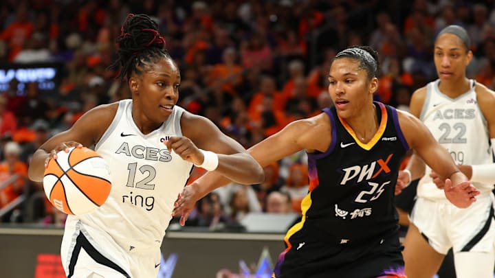 Oct 8, 2025; Phoenix, Arizona, USA; Las Vegas Aces guard Chelsea Gray (12) dribbles the ball past Phoenix Mercury forward Alyssa Thomas (25) in the second half during game three of the 2025 WNBA Finals at PHX Arena. Mandatory Credit: Mark J. Rebilas-Imagn Images
