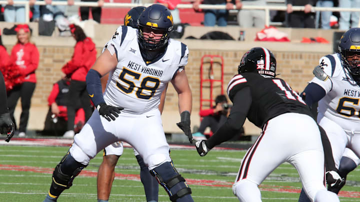 Nov 30, 2024; Lubbock, Texas, USA;  West Virginia Mountaineers offensive tackle Nick Malone (58) blocks Texas Tech Red Raiders defensive back Charles Esters III (11) in the second half at Jones AT&T Stadium and Cody Campbell Field. Mandatory Credit: Michael C. Johnson-Imagn Images