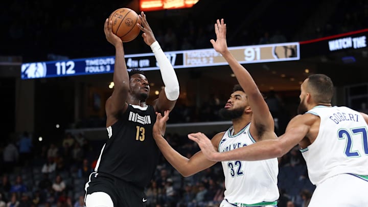 Dec 8, 2023; Memphis, Tennessee, USA; Memphis Grizzlies forward-center Jaren Jackson Jr. (13) drives to the basket as Minnesota Timberwolves center-forward Karl-Anthony Towns (32) defends during the second half at FedExForum. Mandatory Credit: Petre Thomas-Imagn Images