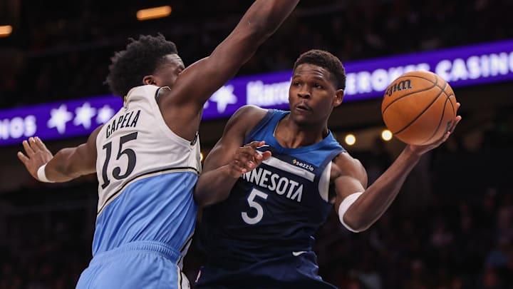 Dec 23, 2024; Atlanta, Georgia, USA; Minnesota Timberwolves guard Anthony Edwards (5) passes the ball around Atlanta Hawks center Clint Capela (15) in the fourth quarter at State Farm Arena. Mandatory Credit: Brett Davis-Imagn Images