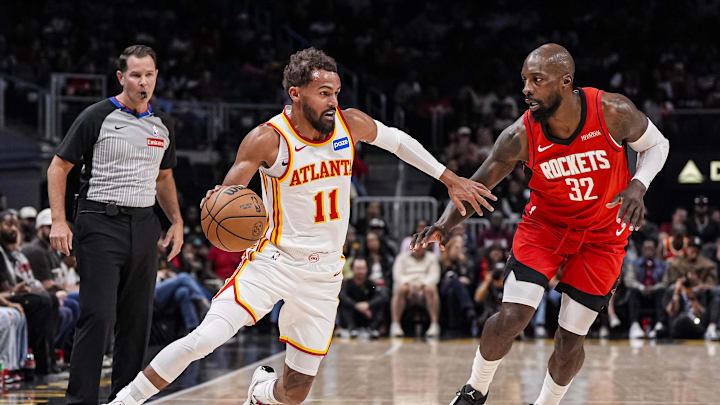 Oct 16, 2025; Atlanta, Georgia, USA; Atlanta Hawks guard Trae Young (11) dribbles against Houston Rockets forward Jeff Green (32) during the first half at State Farm Arena. Mandatory Credit: Dale Zanine-Imagn Images