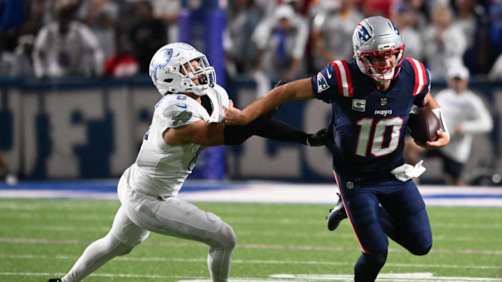 Oct 5, 2025; Orchard Park, New York, USA; New England Patriots quarterback Drake Maye (10) rushes the ball past Buffalo Bills safety Taylor Rapp (9) during the first half at Highmark Stadium. Mandatory Credit: Mark Konezny-Imagn Images