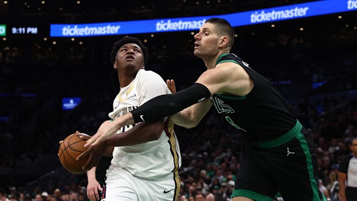 Apr 10, 2026; Boston, Massachusetts, USA; Boston Celtics center Nikola Vucevic (4) tries to knock the ball away from New Orleans Pelicans center Derik Queen (22) during the second half at TD Garden. Mandatory Credit: Winslow Townson-Imagn Images