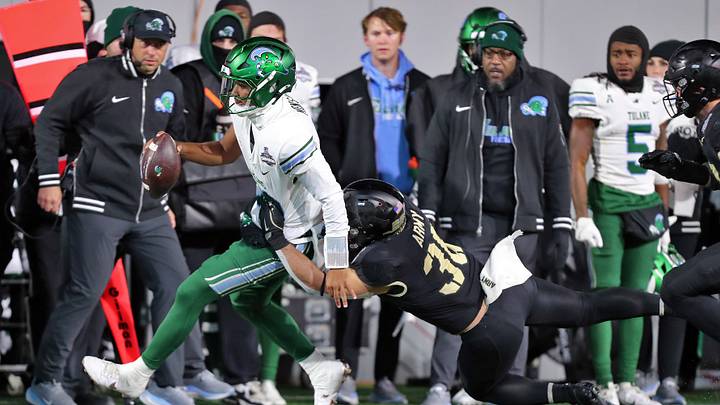 Dec 6, 2024; West Point, NY, USA; Tulane Green Wave quarterback Darian Mensah (10) is brought down by Army Black Knights linebacker Brett Gerena (36) during the second half at Michie Stadium. Mandatory Credit: Danny Wild-Imagn Images Dec 6, 2024; West Point, NY, USA; Tulane Green Wave quarterback Darian Mensah (10) is brought down by Army Black Knights linebacker Brett Gerena (36) during the second half at Michie Stadium. Mandatory Credit: Danny Wild-Imagn Images