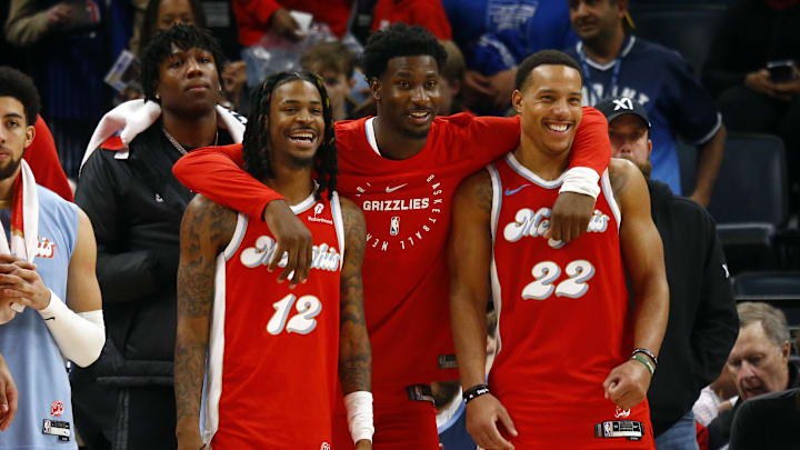 Dec 19, 2024; Memphis, Tennessee, USA; Memphis Grizzlies guard Ja Morant (left), forward Jaren Jackson Jr. (middle) and guard Desmond Bane (right) react during the fourth quarter against the Golden State Warriors at FedExForum. Mandatory Credit: Petre Thomas-Imagn Images