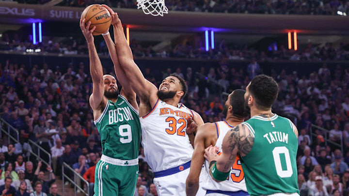 May 10, 2025; New York, New York, USA; Boston Celtics guard Derrick White (9) and New York Knicks center Karl-Anthony Towns (32) fight for a rebound in the first quarter during game three of the second round for the 2025 NBA Playoffs at Madison Square Garden. Mandatory Credit: Wendell Cruz-Imagn Images