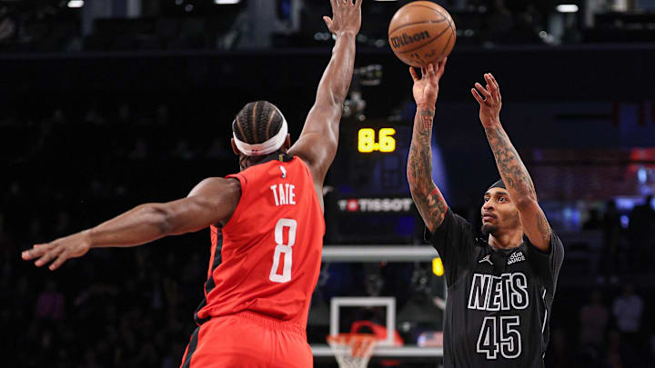 Feb 4, 2025; Brooklyn, New York, USA; Brooklyn Nets guard Keon Johnson (45) shoots the ball as Houston Rockets forward Jae'Sean Tate (8) defends during the second half at Barclays Center. Mandatory Credit: Vincent Carchietta-Imagn Images