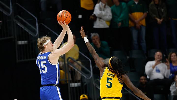 Feb 10, 2026; Waco, Texas, USA;  BYU Cougars guard Richie Saunders (15) scores a basket against Baylor Bears guard Obi Agbim (5) during the first half at Paul and Alejandra Foster Pavilion. Mandatory Credit: Chris Jones-Imagn Images