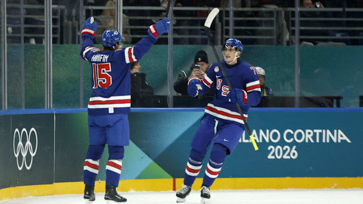 Feb 14, 2026; Milan, Italy;  Noah Hanifin of United States celebrates scoring their fourth goal with Tage Thompson of United States against Denmark in men's ice hockey group C play during the Milano Cortina 2026 Olympic Winter Games at Milano Santagiulia Ice Hockey Arena. Mandatory Credit: Geoff Burke-Imagn Images