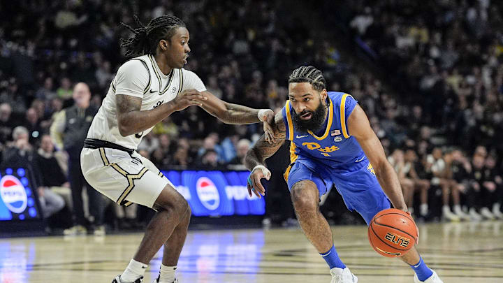 Feb 1, 2025; Winston-Salem, North Carolina, USA; Pittsburgh Panthers guard Damian Dunn (1) goes to the basket defended by Wake Forest Demon Deacons guard Ty-Laur Johnson (8) during the second half at Lawrence Joel Veterans Memorial Coliseum. Mandatory Credit: Jim Dedmon-Imagn Images