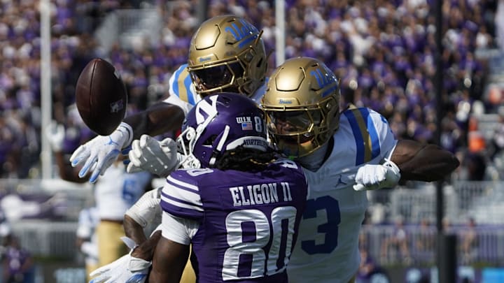 Sep 27, 2025; Evanston, Illinois, USA;UCLA Bruins defensive back Key Lawrence (4) and defensive back Robert Stafford III (3) defends Northwestern Wildcats wide receiver Hayden Eligon II (80) during the first half at Northwestern Medicine Field at Martin Stadium. Mandatory Credit: David Banks-Imagn Images Sep 27, 2025; Evanston, Illinois, USA;UCLA Bruins defensive back Key Lawrence (4) and defensive back Robert Stafford III (3) defends Northwestern Wildcats wide receiver Hayden Eligon II (80) during the first half at Northwestern Medicine Field at Martin Stadium. Mandatory Credit: David Banks-Imagn Images