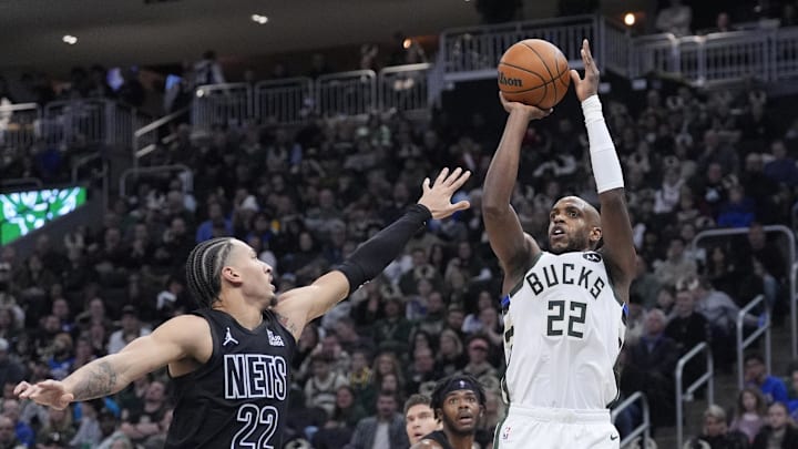 Jan 2, 2025; Milwaukee, Wisconsin, USA; Milwaukee Bucks forward Khris Middleton (22) puts up a shot against Brooklyn Nets forward Jalen Wilson (22) in the first half at Fiserv Forum. Mandatory Credit: Michael McLoone-Imagn Images