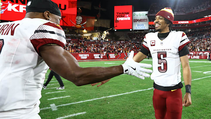 Jan 12, 2025; Tampa, Florida, USA; Washington Commanders quarterback Jayden Daniels (5) celebrates with wide receiver Terry McLaurin (17) after winning a NFC wild card playoff against the Tampa Bay Buccaneers at Raymond James Stadium. Mandatory Credit: Kim Klement Neitzel-Imagn Images