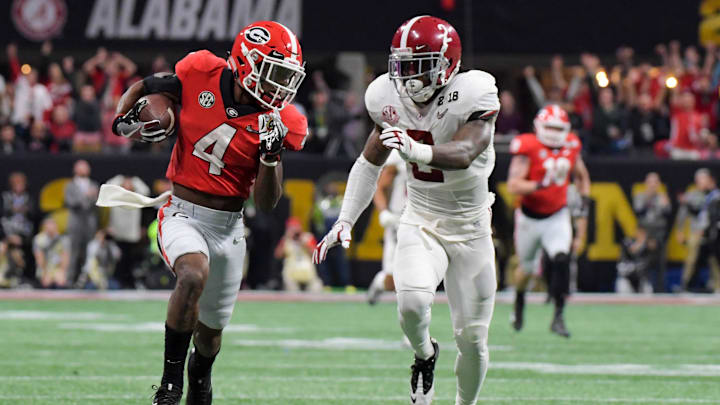 Jan 8, 2018; Atlanta, GA, USA; Georgia Bulldogs wide receiver Mecole Hardman (4) runs the ball for a touchdown ahead of Alabama Crimson Tide defensive back Tony Brown (2) during the third quarter in the 2018 CFP national championship college football game at Mercedes-Benz Stadium. Mandatory Credit: Kirby Lee-Imagn Images Jan 8, 2018; Atlanta, GA, USA; Georgia Bulldogs wide receiver Mecole Hardman (4) runs the ball for a touchdown ahead of Alabama Crimson Tide defensive back Tony Brown (2) during the third quarter in the 2018 CFP national championship college football game at Mercedes-Benz Stadium. Mandatory Credit: Kirby Lee-Imagn Images