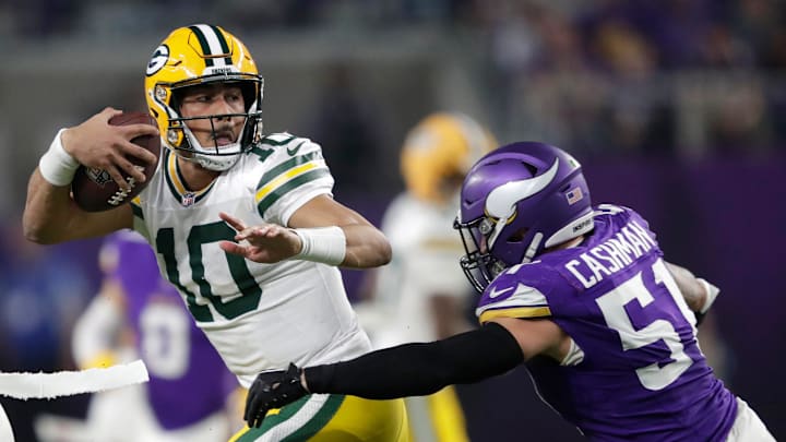Green Bay Packers quarterback Jordan Love (10) is tackled by Minnesota Vikings linebacker Blake Cashman.