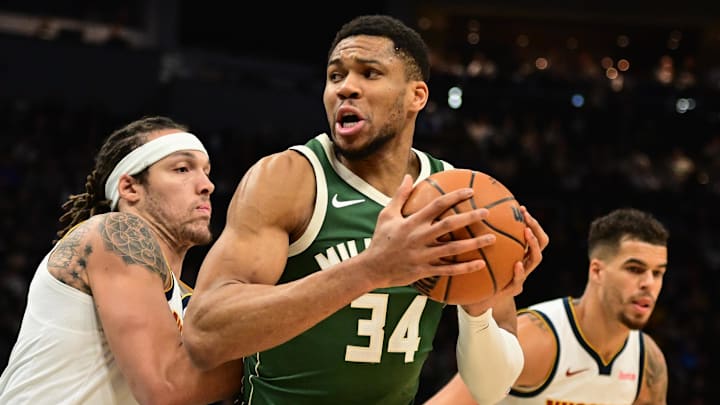 Feb 27, 2025; Milwaukee, Wisconsin, USA; Milwaukee Bucks forward Giannis Antetokounmpo (34) looks for a shot against Denver Nuggets forward Aaron Gordon (32) in the first quarter at Fiserv Forum. Mandatory Credit: Benny Sieu-Imagn Images