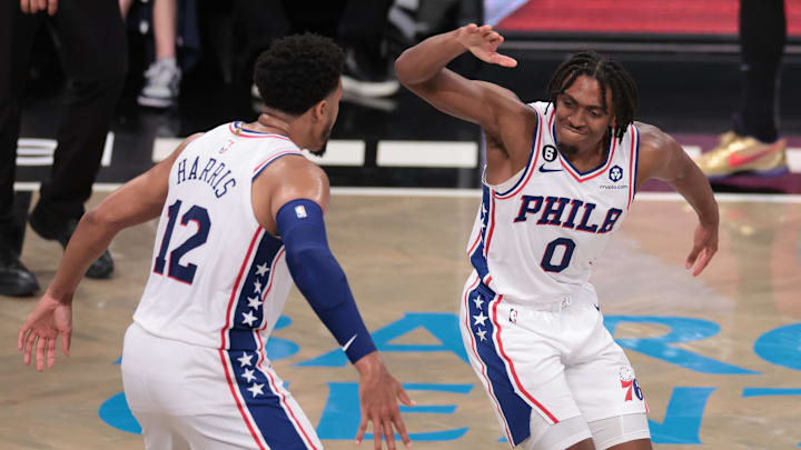 Apr 22, 2023; Brooklyn, New York, USA; Philadelphia 76ers guard Tyrese Maxey (0) celebrates with forward Tobias Harris (12) after a basket against the Brooklyn Nets during the second half of game four of the 2023 NBA playoffs at Barclays Center. Mandatory Credit: Vincent Carchietta-Imagn Images