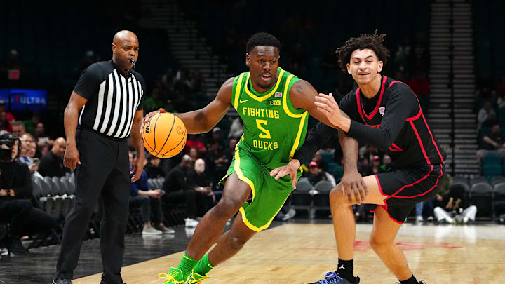 Nov 27, 2024; Las Vegas, Nevada, USA; Oregon Ducks guard TJ Bamba (5) dribbles against San Diego State Aztecs guard Miles Byrd (21) during the first half at MGM Grand Garden Arena. Mandatory Credit: Stephen R. Sylvanie-Imagn Images