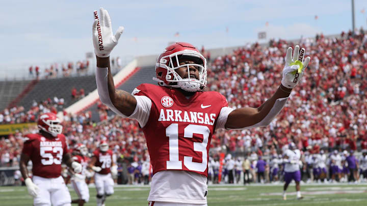Sep 2, 2023; Little Rock, Arkansas, USA; Arkansas Razorbacks wide receiver Jaedon Wilson (13) celebrates after scoring a touchdown in the first quarter against the Western Carolina Catamounts at War Memorial Stadium. Mandatory Credit: Nelson Chenault-Imagn Images
