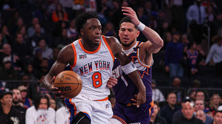 Apr 6, 2025; New York, New York, USA; New York Knicks forward OG Anunoby (8) is defended by Phoenix Suns guard Devin Booker (1) during the second half at Madison Square Garden. Mandatory Credit: Vincent Carchietta-Imagn Images