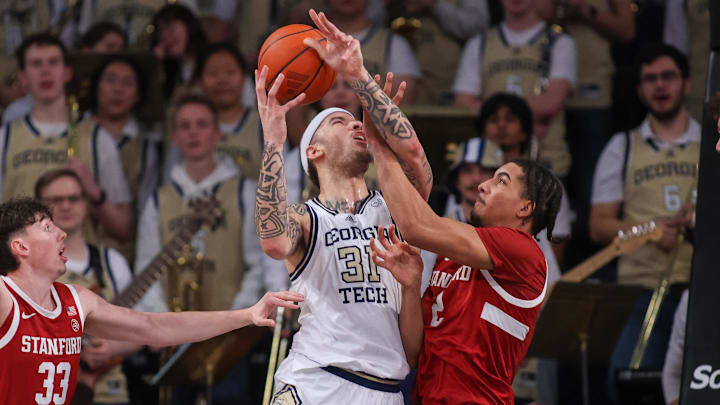 Feb 12, 2025; Atlanta, Georgia, USA; Georgia Tech Yellow Jackets forward Duncan Powell (31) shoots past Stanford Cardinal forward Evan Stinson (33) and forward Donavin Young (2) in the first half at McCamish Pavilion. Mandatory Credit: Brett Davis-Imagn Images