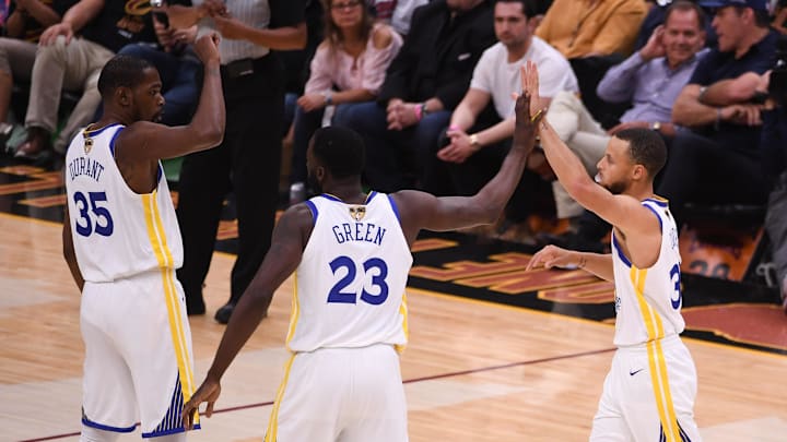 June 8, 2018; Cleveland, OH, USA; Golden State Warriors forward Kevin Durant (35), forward Draymond Green (23), and guard Stephen Curry (30) high-five during the first quarter in game four of the 2018 NBA Finals against the Cleveland Cavaliers at Quicken Loans Arena. The Warriors defeated the Cavaliers 108-85 to complete a four-game sweep. Mandatory Credit: Kyle Terada-Imagn Images