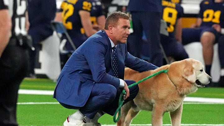 Jan 8, 2024; Houston, TX, USA; ESPN analyst Kirk Herbstreit walks his dog Ben before the 2024 College Football Playoff national championship game between the Michigan Wolverines and the Washington Huskies at NRG Stadium. Mandatory Credit: Kirby Lee-Imagn Images