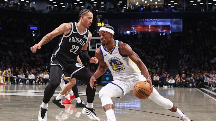 Mar 6, 2025; Brooklyn, New York, USA;  Golden State Warriors forward Jimmy Butler III (10) looks to drive past Brooklyn Nets forward Jalen Wilson (22) in the first quarter at Barclays Center. Mandatory Credit: Wendell Cruz-Imagn Images