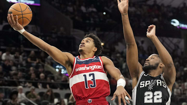 Nov 13, 2024; San Antonio, Texas, USA; Washington Wizards guard Jordan Poole (13) drives to the basket past San Antonio Spurs guard Malaki Branham (22) during the second half at Frost Bank Center. Mandatory Credit: Scott Wachter-Imagn Images